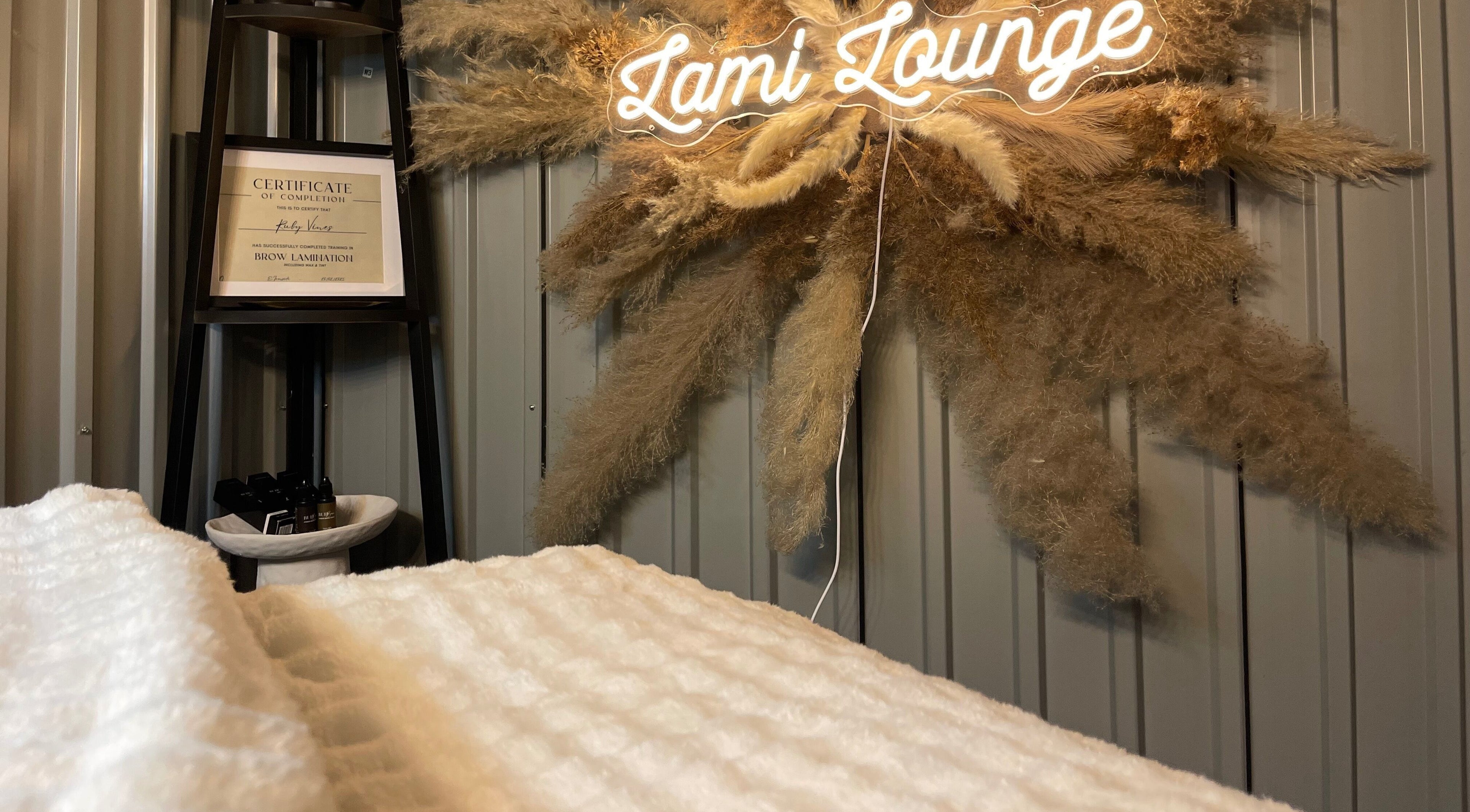 Warm interior of Lami Lounge UK in Spalding, England, GB with neon sign and pampas decor.