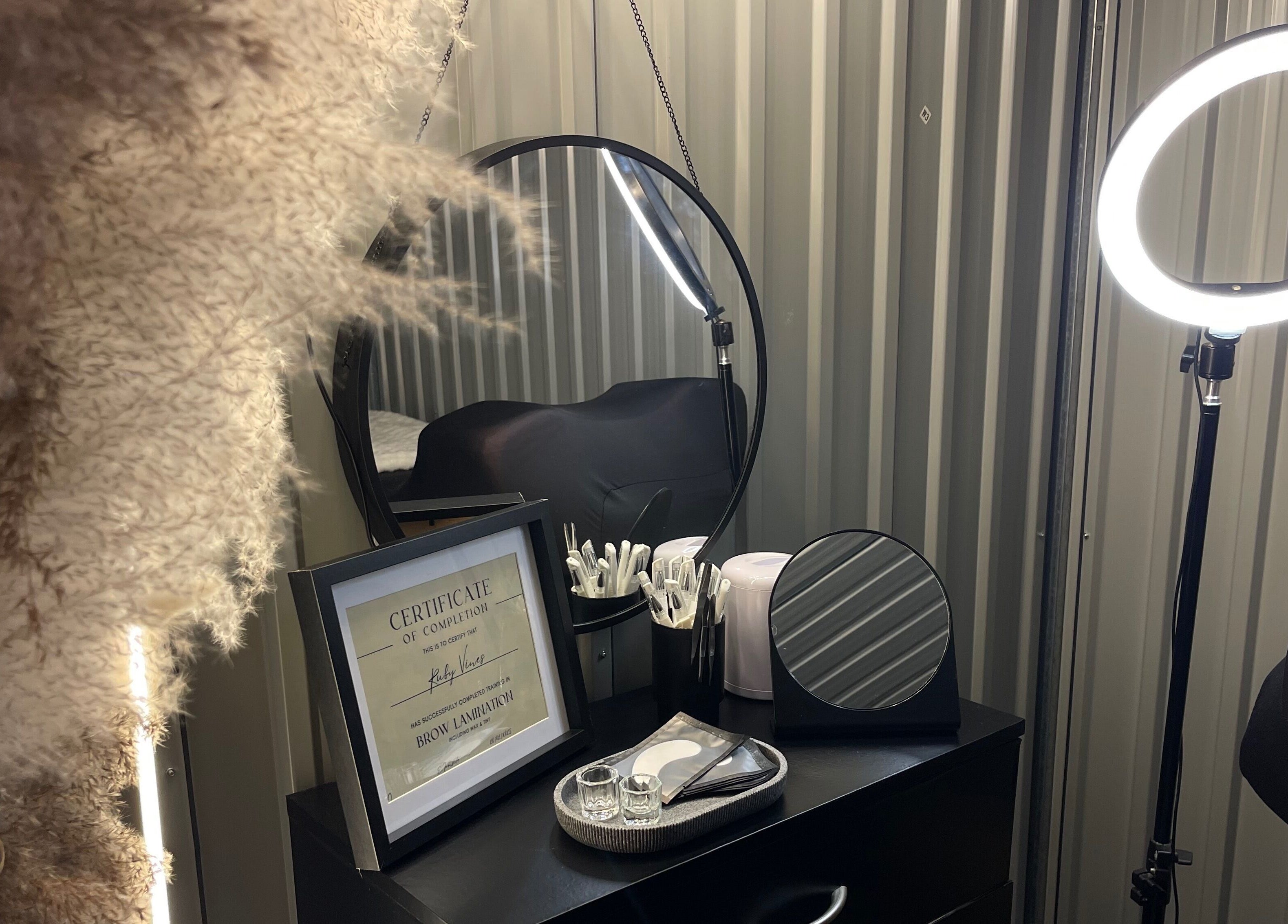 A cozy corner at Lami Lounge UK, Spalding, England, GB, featuring beauty tools, a mirror, and ring light.
