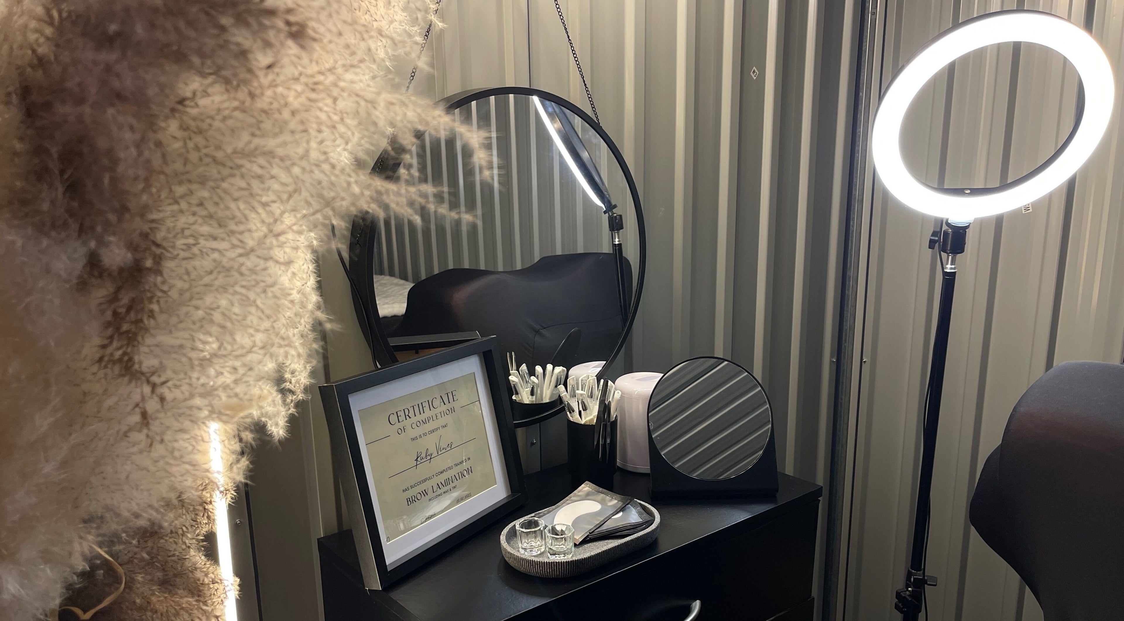 A cozy corner at Lami Lounge UK, Spalding, England, GB, featuring beauty tools, a mirror, and ring light.
