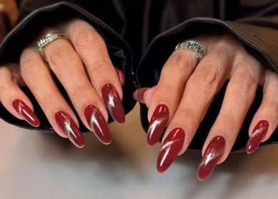 Elegant red manicure at Nailsby.didar, Stockport, England, GB showcasing intricate nail art design.