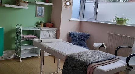 Tranquil treatment room at Tamed and Wild Fishponds, Bristol, England, GB, featuring a cozy massage table.