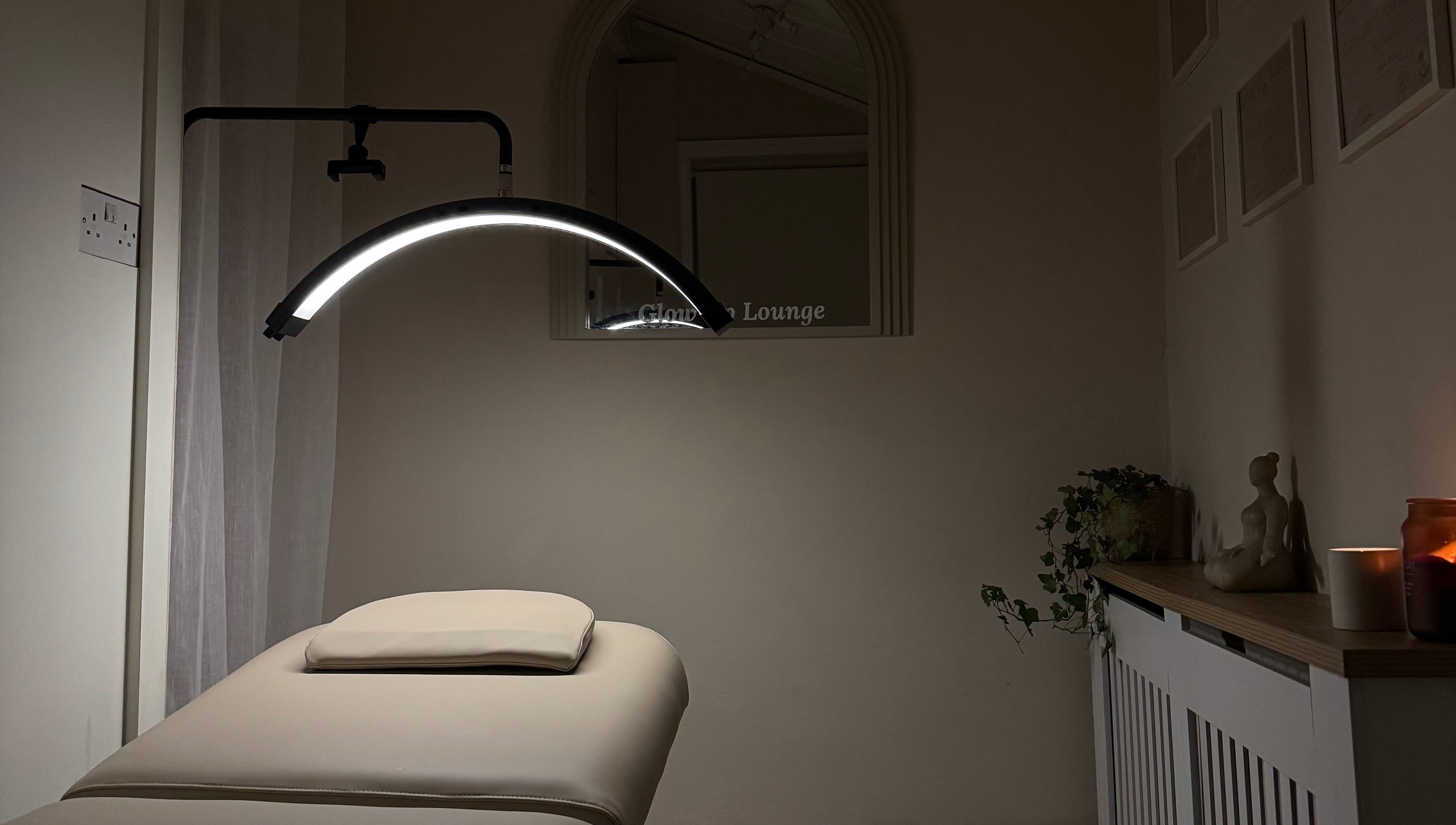 Serene massage room at Glow Up Lounge, Accrington, England, GB with soft lighting and a massage table.