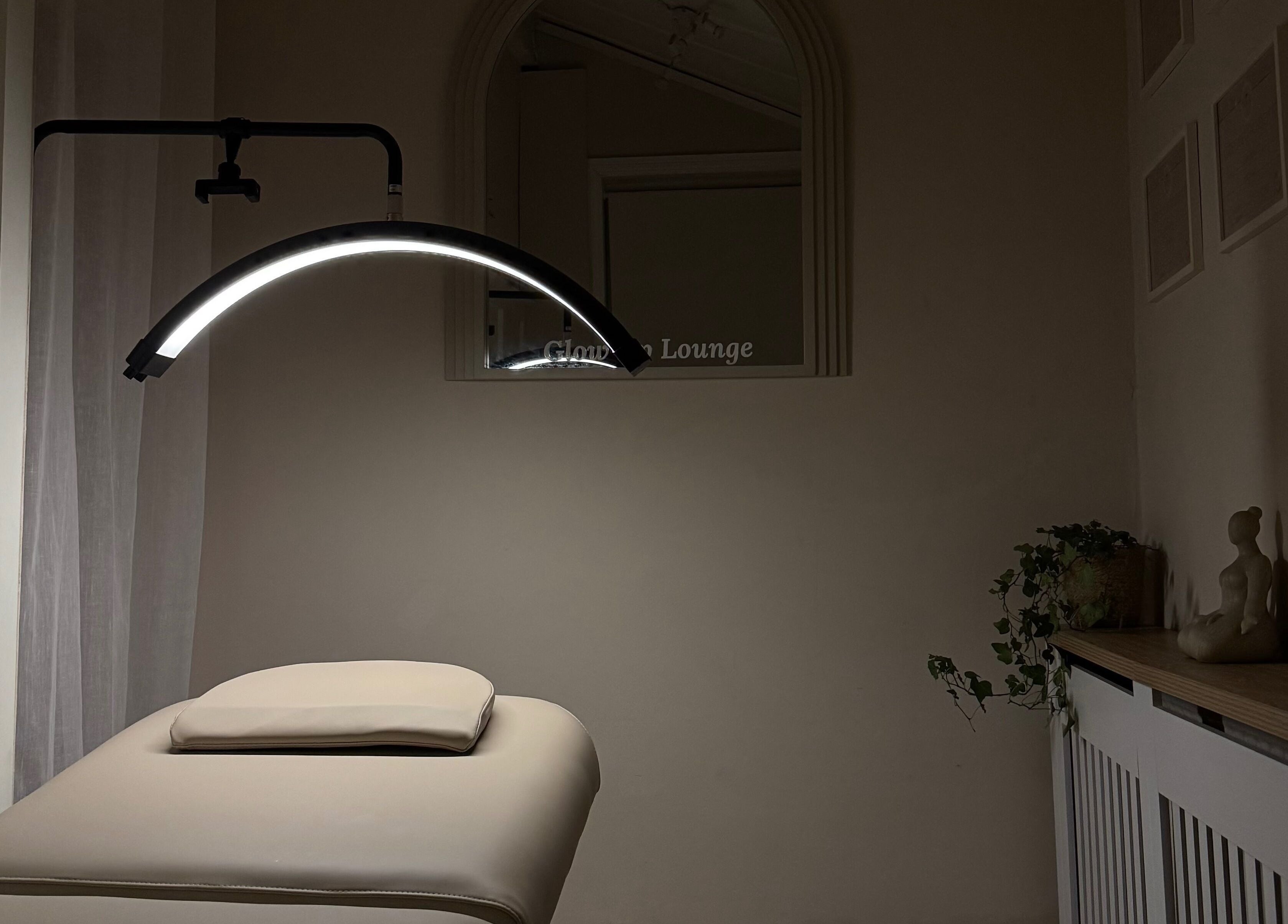 Serene massage room at Glow Up Lounge, Accrington, England, GB with soft lighting and a massage table.