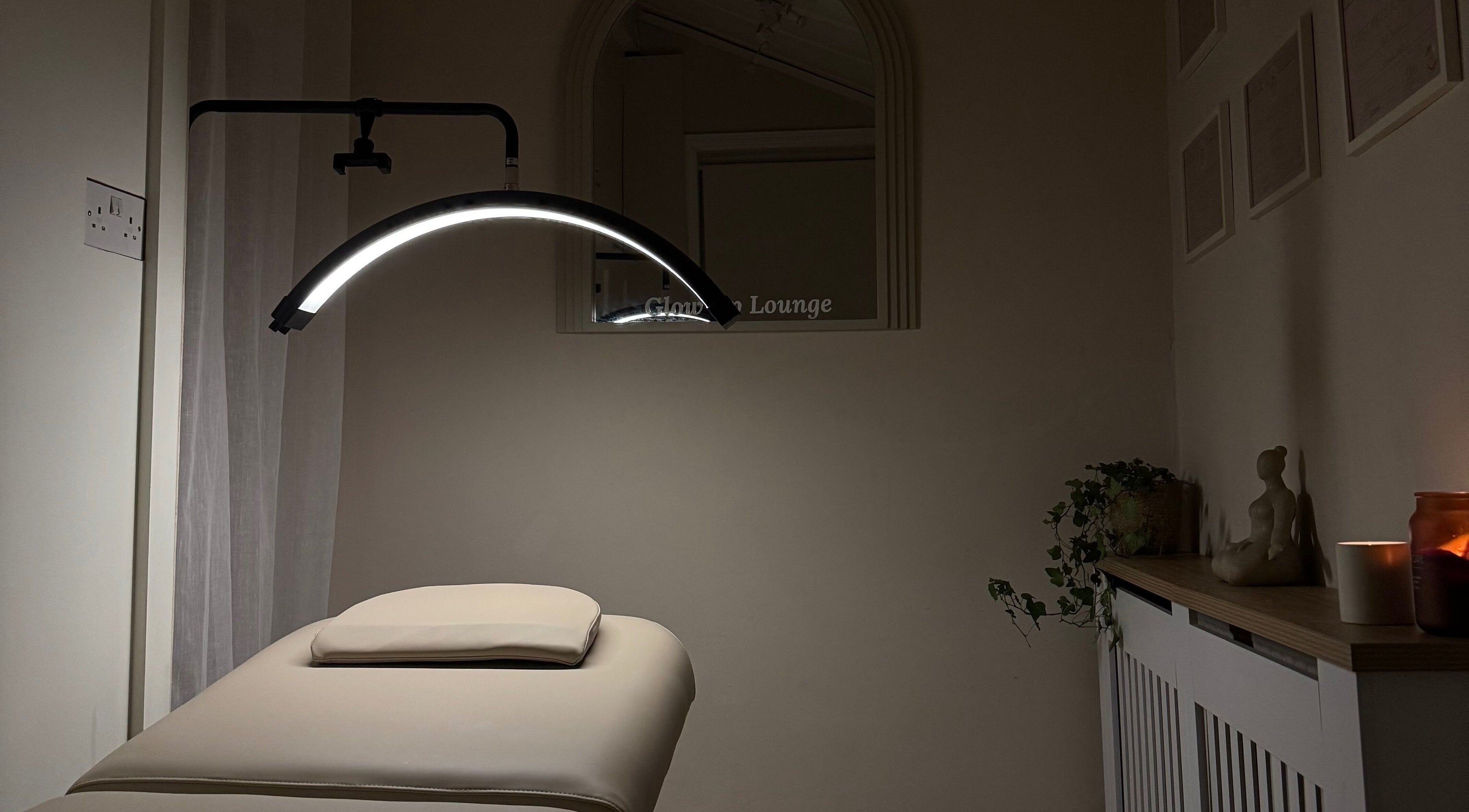 Serene massage room at Glow Up Lounge, Accrington, England, GB with soft lighting and a massage table.