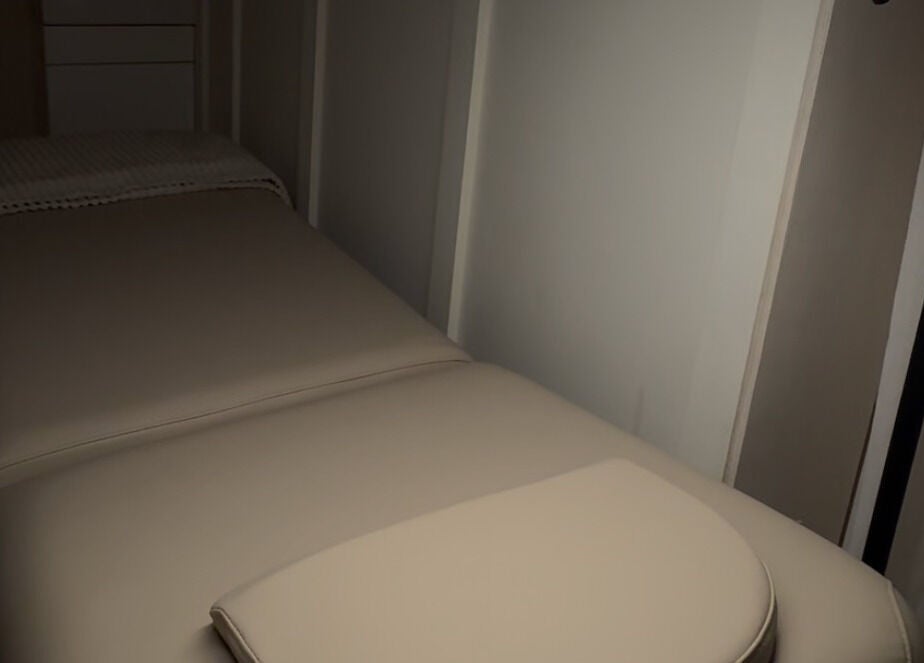 Cozy treatment room at Glow Up Lounge, Accrington, England, GB with a plush massage table.