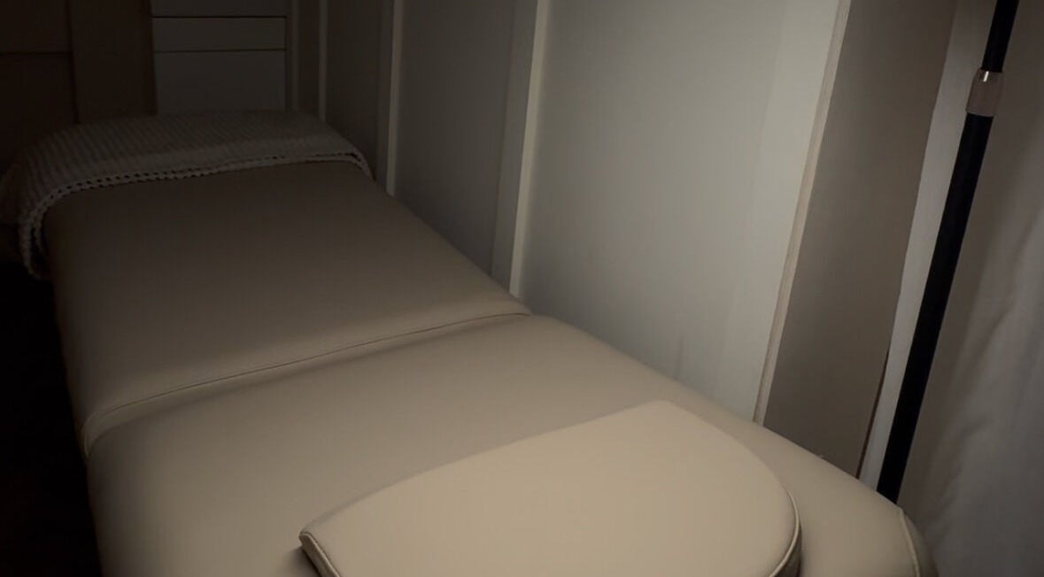 Cozy treatment room at Glow Up Lounge, Accrington, England, GB with a plush massage table.