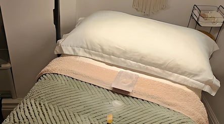 Relaxing massage table at Healing Hands Studio, Southampton, GB, adorned with soft linens.