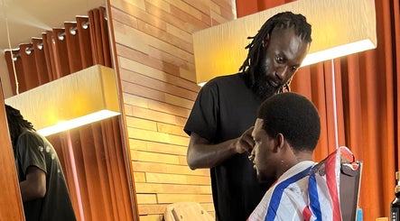 Barber styling a client's hair at Nana Rulz, Cape Town, Western Cape, ZA.