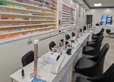 Elegant nail stations at Viet Nails and Beauty, Dublin, County Dublin, IE, with colorful polish display.