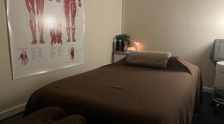 Cozy massage room at R.G Motion Therapy, Claremont Meadows, New South Wales, AU, featuring anatomical poster.