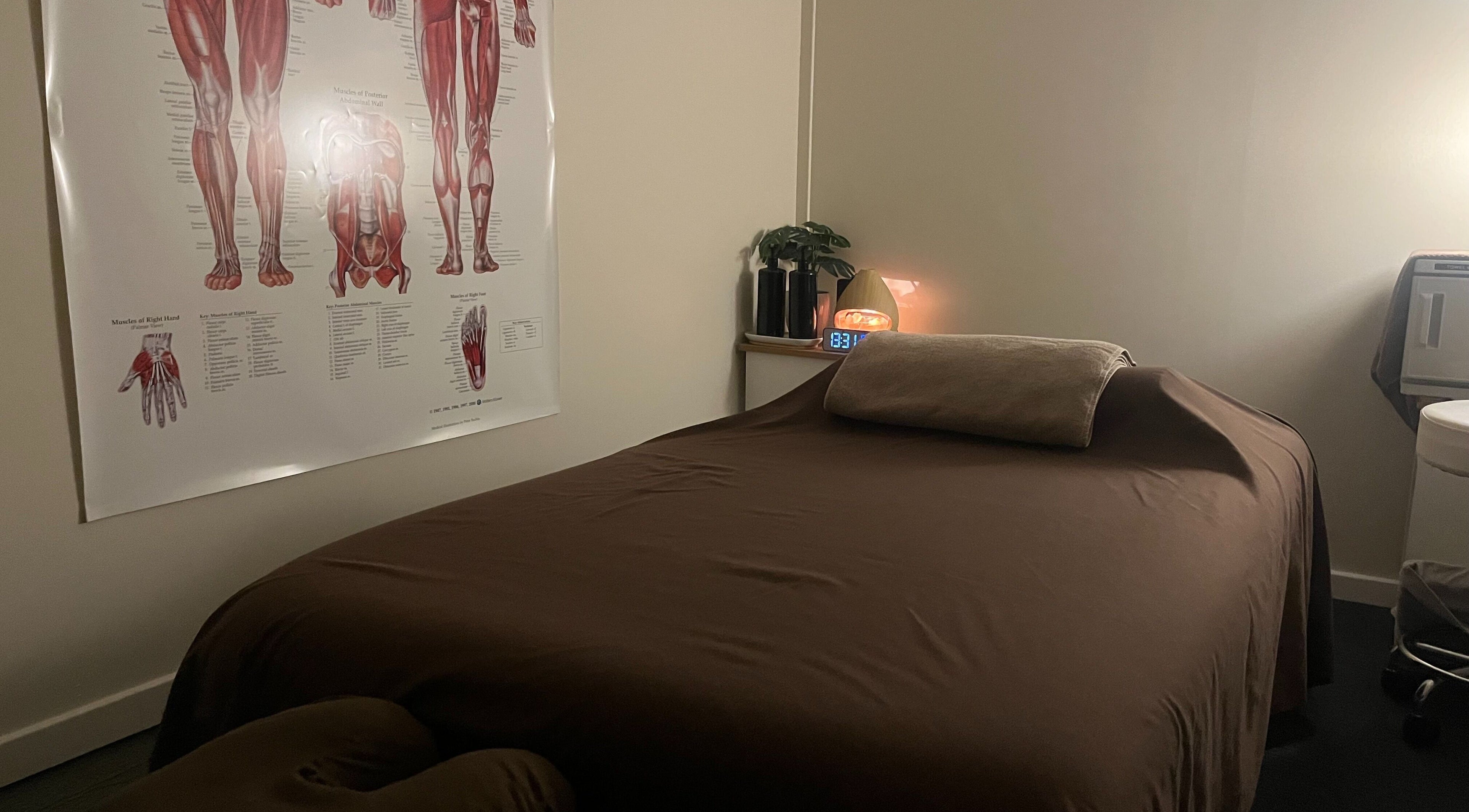Cozy massage room at R.G Motion Therapy, Claremont Meadows, New South Wales, AU, featuring anatomical poster.