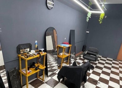 Sleek interior of Borneo Barbershop Putatan, featuring checked floors and modern decor in Putatan, Sabah, MY.