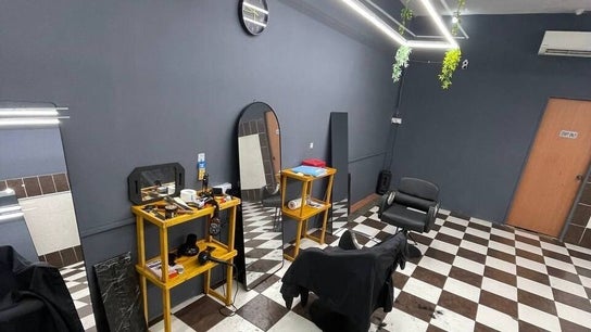 Sleek interior of Borneo Barbershop Putatan, featuring checked floors and modern decor in Putatan, Sabah, MY.
