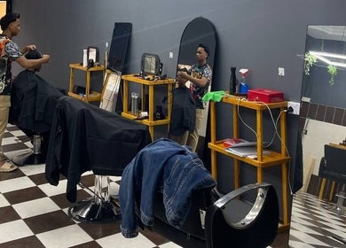 Interior of Borneo Barbershop Putatan showcasing a stylist in action in Putatan, Sabah, MY.
