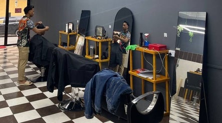 Interior of Borneo Barbershop Putatan showcasing a stylist in action in Putatan, Sabah, MY.