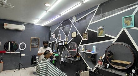 Modern interior of Borneo Barbershop Sabindo in Penampang, Sabah, MY with stylist and client.