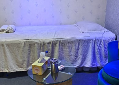 Relaxing massage room at Frozen Thai Spa - Spa in Dhaka, Dhaka Division, BD with blue chair and table.