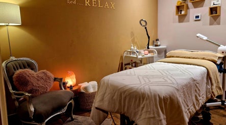 Relaxing treatment room at The Three Elements - Day Spa & Detox, London, England, GB, featuring soft lighting.