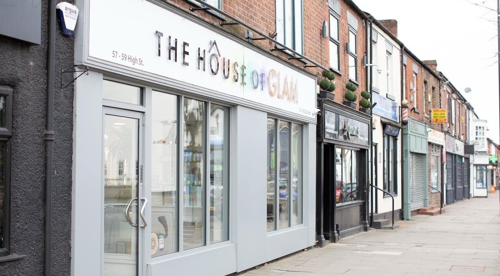 The House of Glam entrance on High St, Newton-le-Willows, England, GB, showcasing modern style.