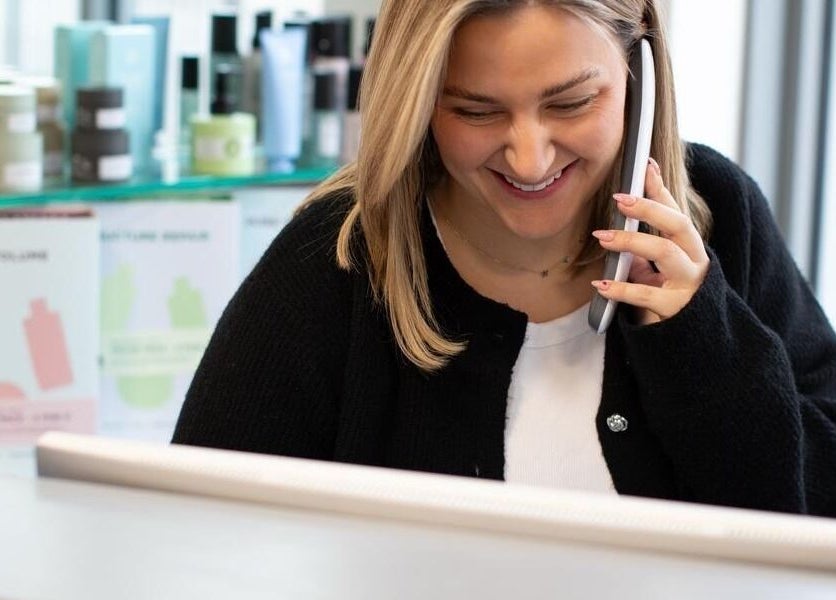 Friendly receptionist answering phone at The House of Glam in Newton-le-willows, England, GB.