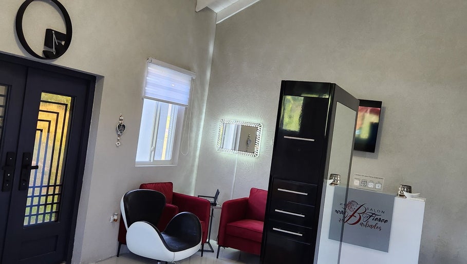 Modern lounge area at B Fierce Salon Barbados in Deanes, Saint James, BB featuring stylish chairs and decor.
