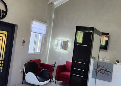 Modern lounge area at B Fierce Salon Barbados in Deanes, Saint James, BB featuring stylish chairs and decor.