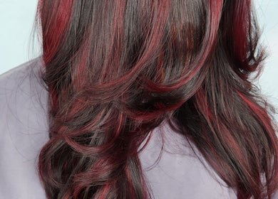 Elegant crimson hair styling at B Fierce Salon Barbados, Deanes, Saint James, BB showcasing glossy red highlights.