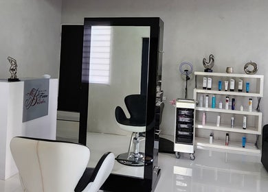 Modern interior of B Fierce Salon Barbados, Deanes, Saint James, BB, showcasing sleek chairs and beauty products.