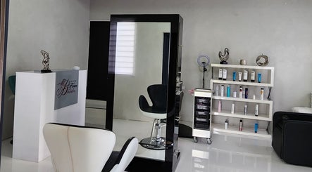 Modern interior of B Fierce Salon Barbados, Deanes, Saint James, BB, showcasing sleek chairs and beauty products.