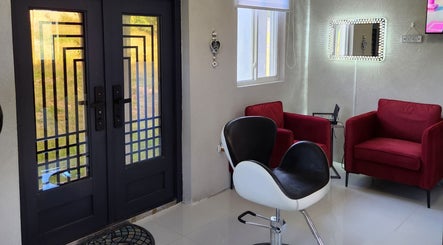 Modern waiting area at B Fierce Salon Barbados, Deanes, Saint James, BB with red chairs and mirrored decor.