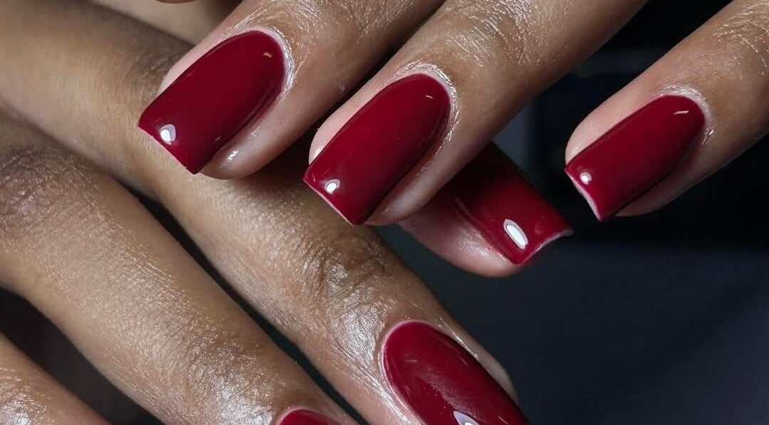 Elegant red manicure at Leetalia nails & beauty, Randburg, Gauteng, ZA showcasing high gloss finish.