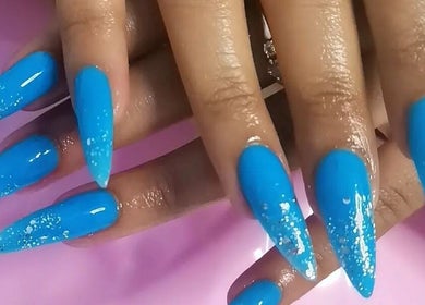 Vibrant blue acrylic nails with glitter finish at Leetalia Nails & Beauty, Randburg, Gauteng, ZA.