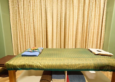 Massage bed with elegant decor at Chabaa Thai & Remedial Massage, Surry Hills, New South Wales, AU.