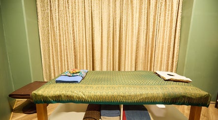 Massage bed with elegant decor at Chabaa Thai & Remedial Massage, Surry Hills, New South Wales, AU.