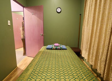 Tranquil massage room at Chabaa Thai & Remedial Massage, Surry Hills, New South Wales, AU with a decorated bed.