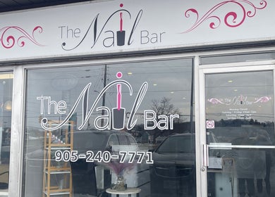 Front of The Nail Bar in Oshawa, Ontario, CA, showcasing elegant signage and services.