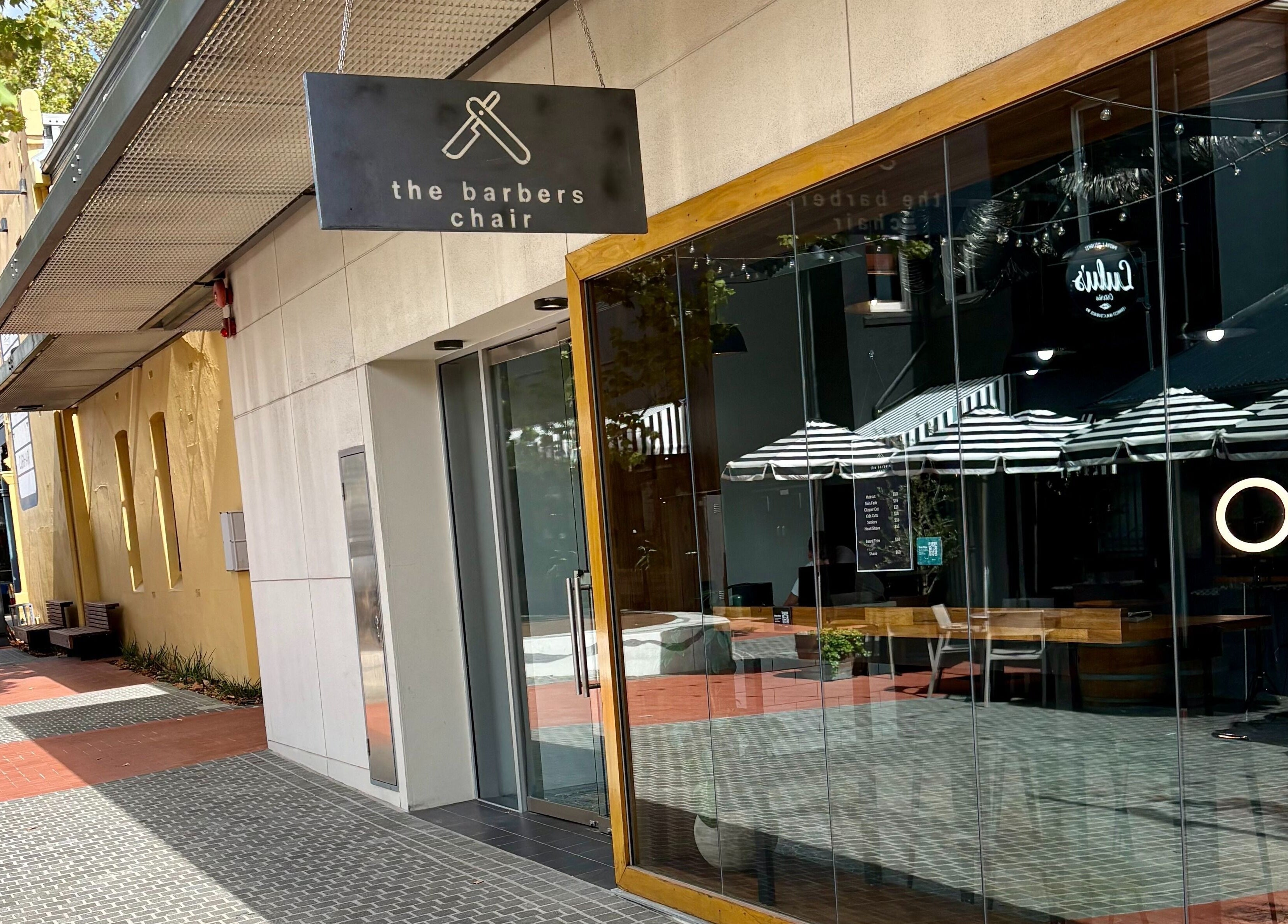Street view of The Barbers Chair in Subiaco, Western Australia, AU. Glass facade and inviting entrance.