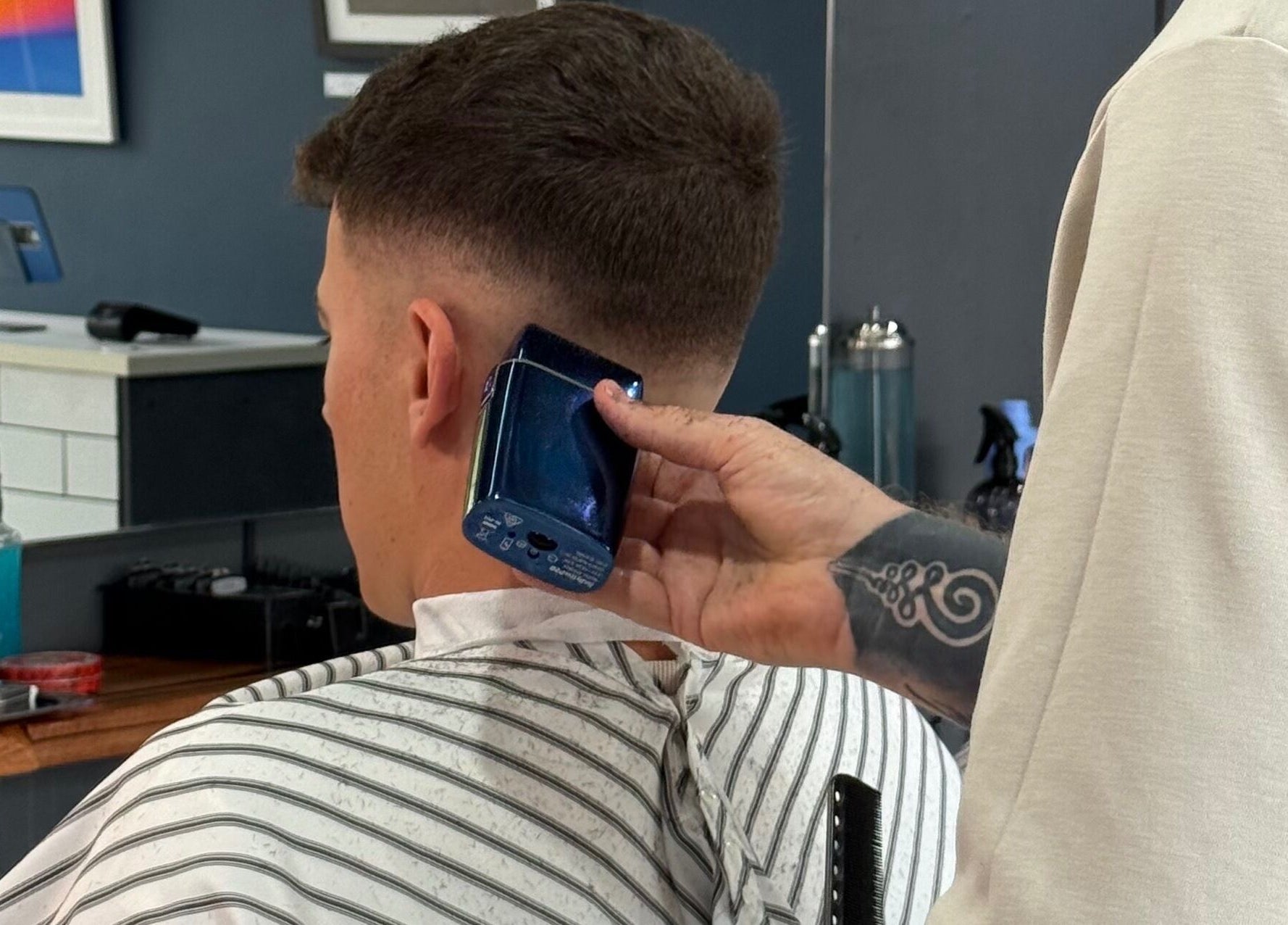 A barber creates a fade haircut at The Barbers Chair, Subiaco, Western Australia, AU.