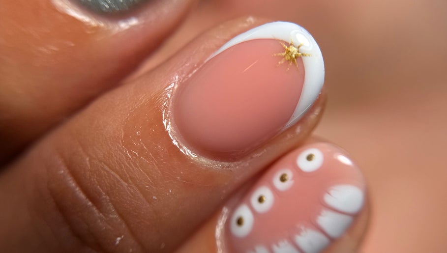 Elegant nail art at Blessed Nails in Kangaroo Point, Queensland, AU, featuring unique gold and white designs.