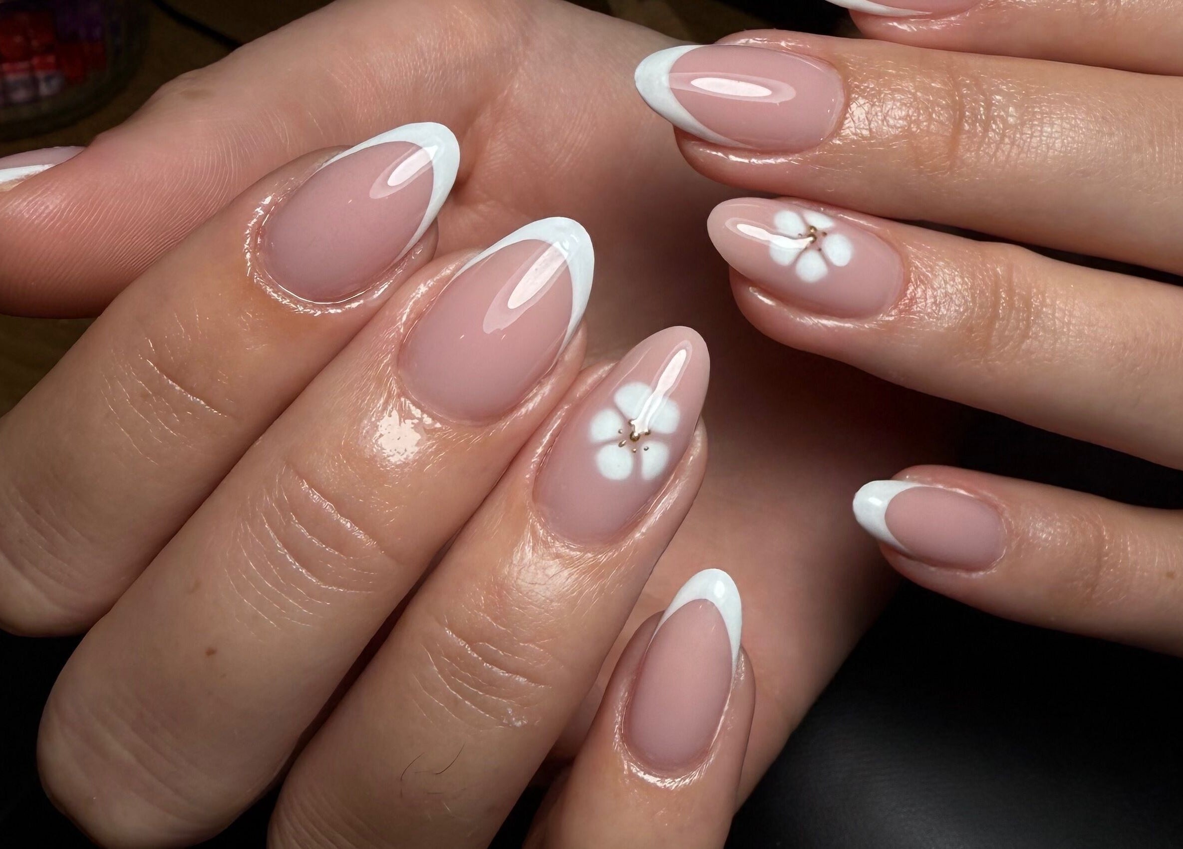 Elegant French manicure with floral design at Blessed Nails, Kangaroo Point, Queensland, AU.