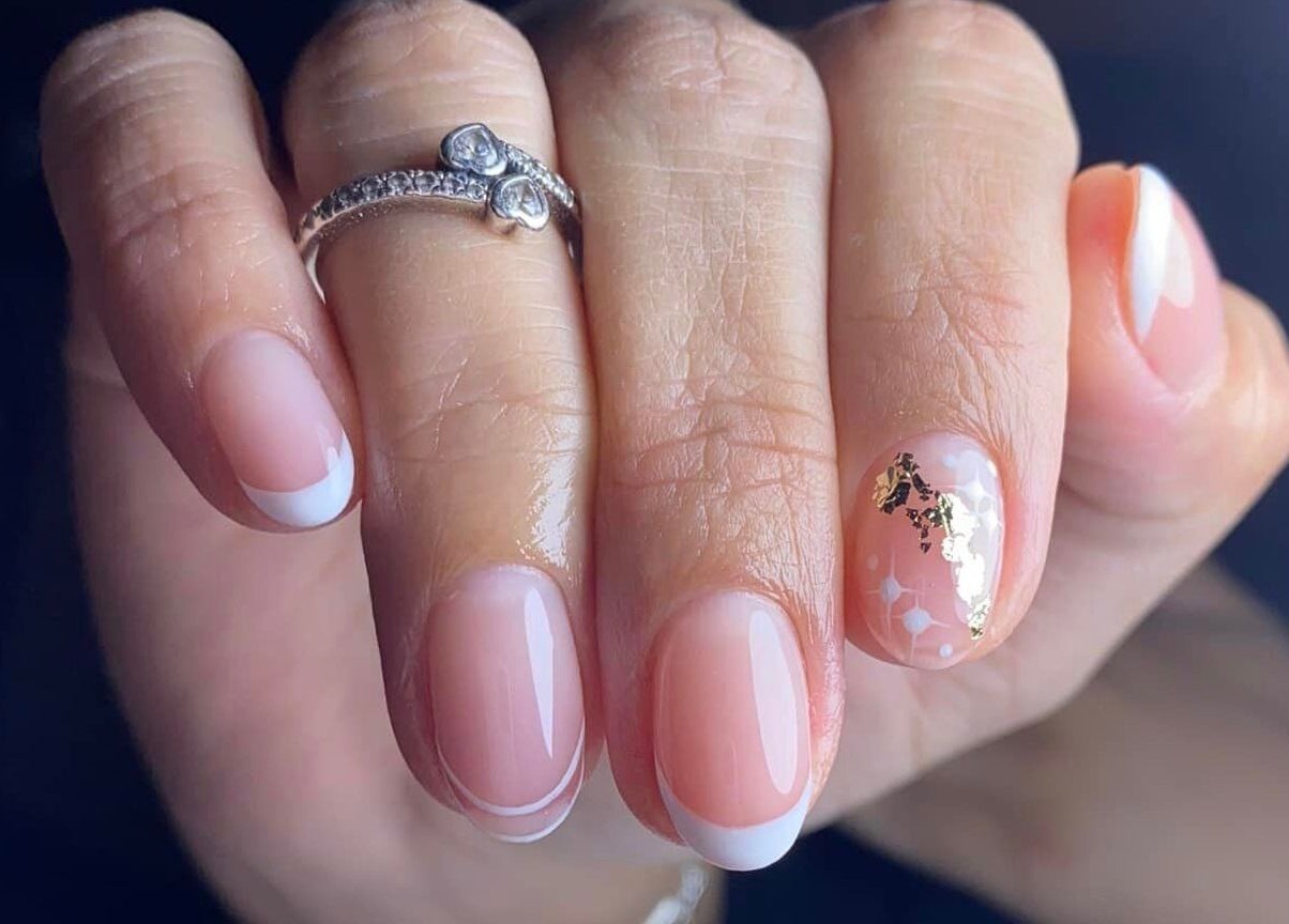 Elegant French manicure with gold accents at Blessed Nails, Kangaroo Point, Queensland, AU.