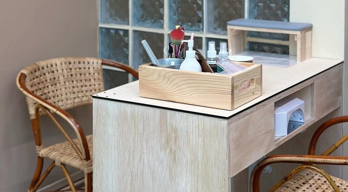 ChilliPedi by Tiny Fingers, Singapore - Elegant salon setup with wicker chairs and wooden table in SG.