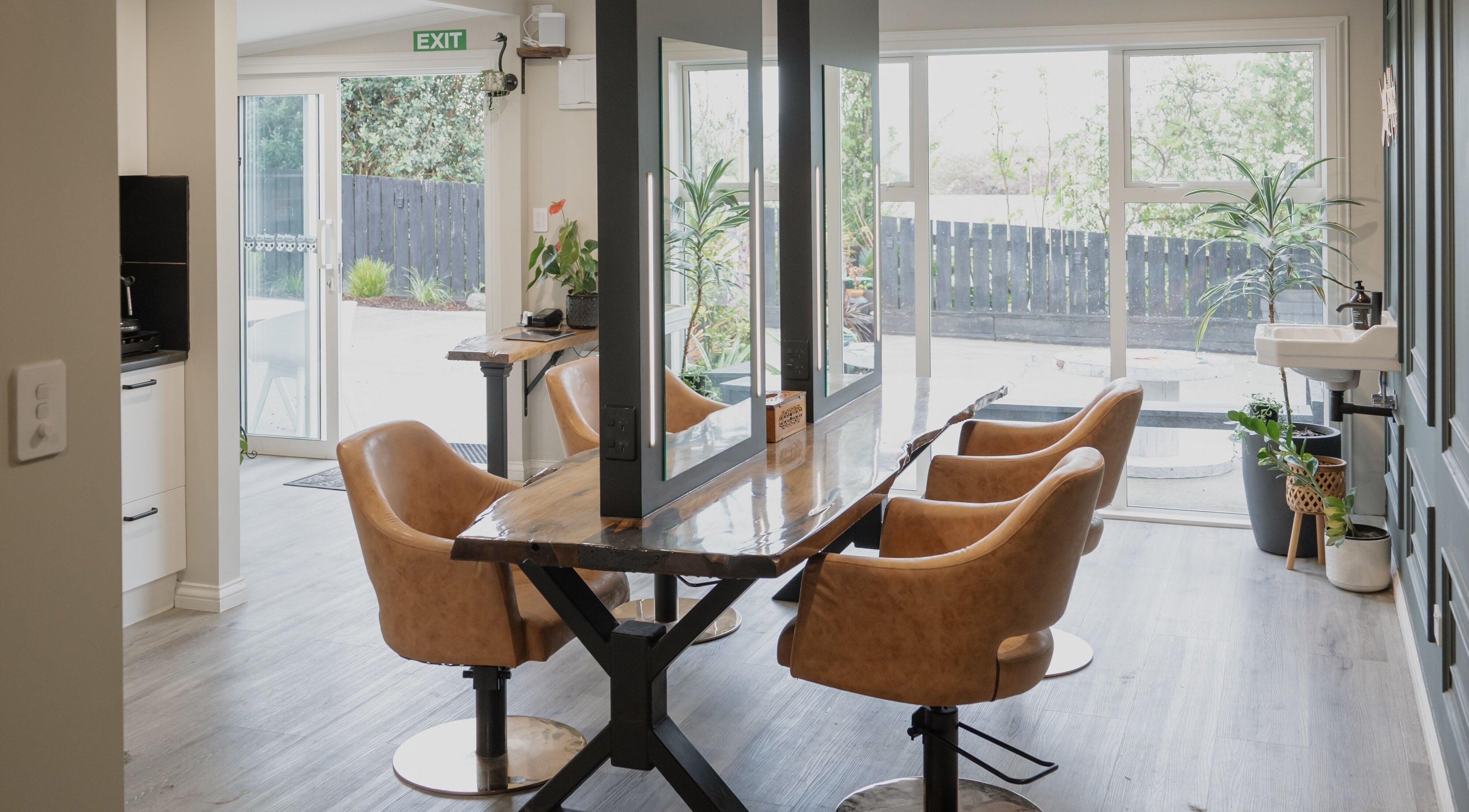 Modern salon interior at District Blonde in Tauranga, Bay of Plenty, NZ with stylish leather chairs.