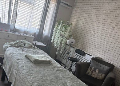Calming treatment room at LEL’s Beauty, Tividale, England, GB, featuring a cozy massage table and elegant decor.