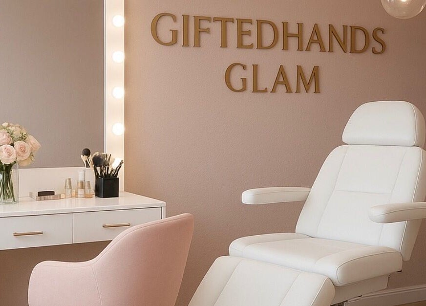 Elegant beauty salon interior at Gitedhands Glam, Beckenham, England, GB with white chair and vanity mirror.