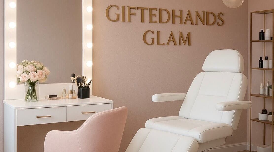 Elegant beauty salon interior at Gitedhands Glam, Beckenham, England, GB with white chair and vanity mirror.