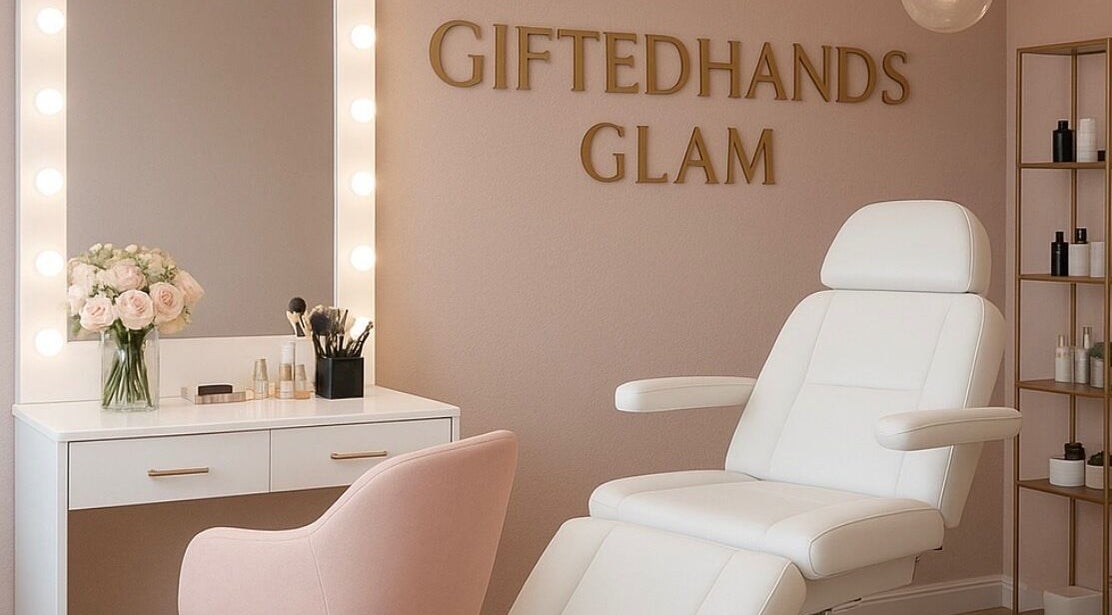 Elegant beauty salon interior at Gitedhands Glam, Beckenham, England, GB with white chair and vanity mirror.