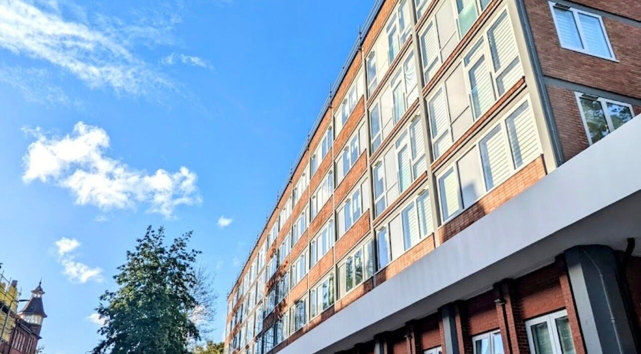 Gitedhands Glam venue exterior, modern facade in Beckenham, England, GB, against a bright blue sky.