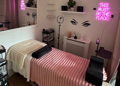 Elegant lash treatment room at Lashed By Xio, London, England, GB, with pink decor and relaxing elements.