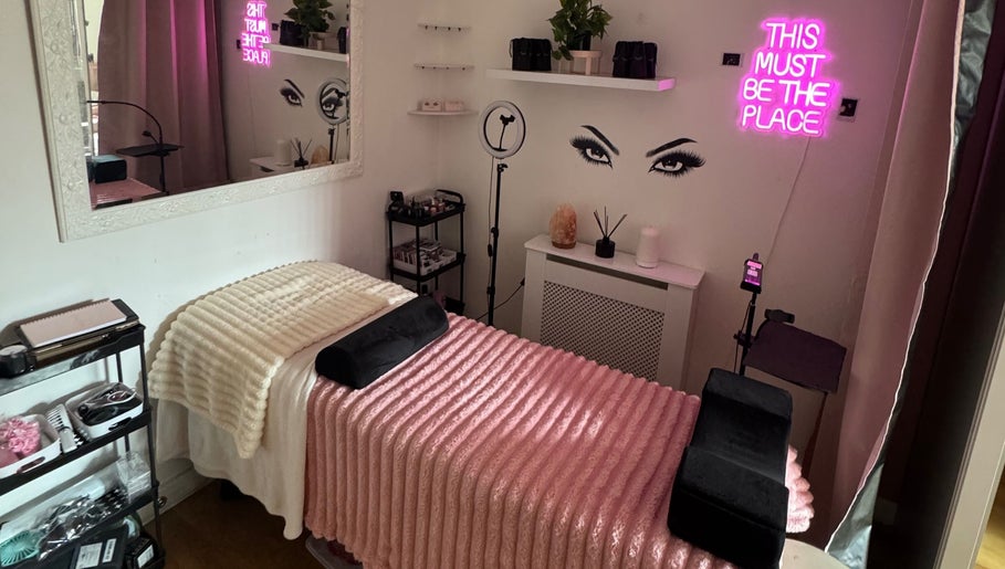 Chic lash salon room at Lashed By Xio in London, England, GB with plush decor and neon sign.